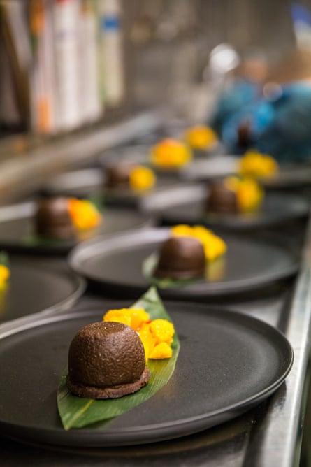 Self-saucing chocolate pudding with mandarin salsa.