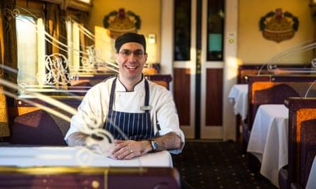 Indian Pacific Railway chef sits onboard in the Queen Adelaide restaurant car.