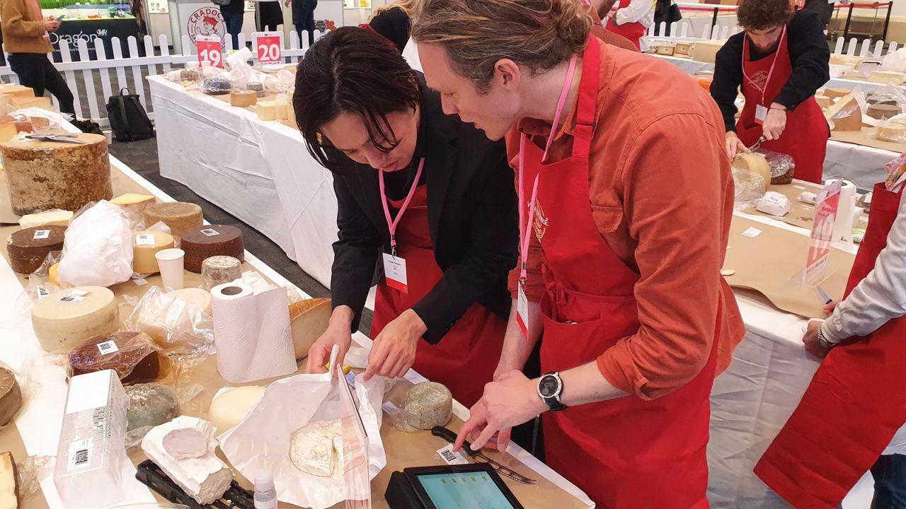 Judges Kazuaki Tomiyama  and Tom Chatfield sample the cheeses on table 18.